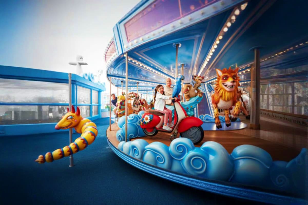 Children riding colorful scooter-themed carousel ride with friendly monster characters at Genting Skytropolis Indoor Theme Pa