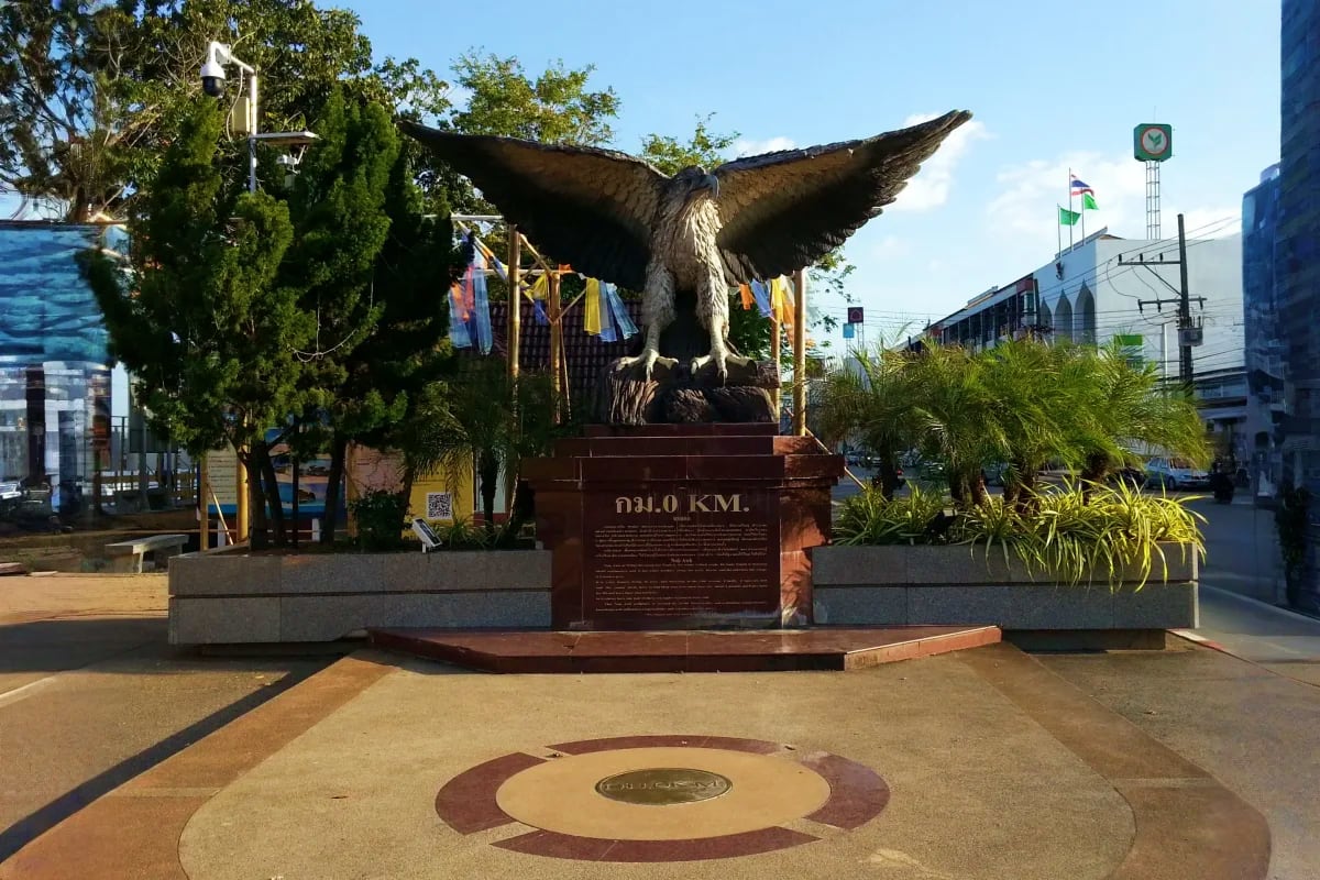 Krabi City Tour Eagle monument statue with spread wings at Krabi City 0 KM marker, Thailand street landmark with informational plaque