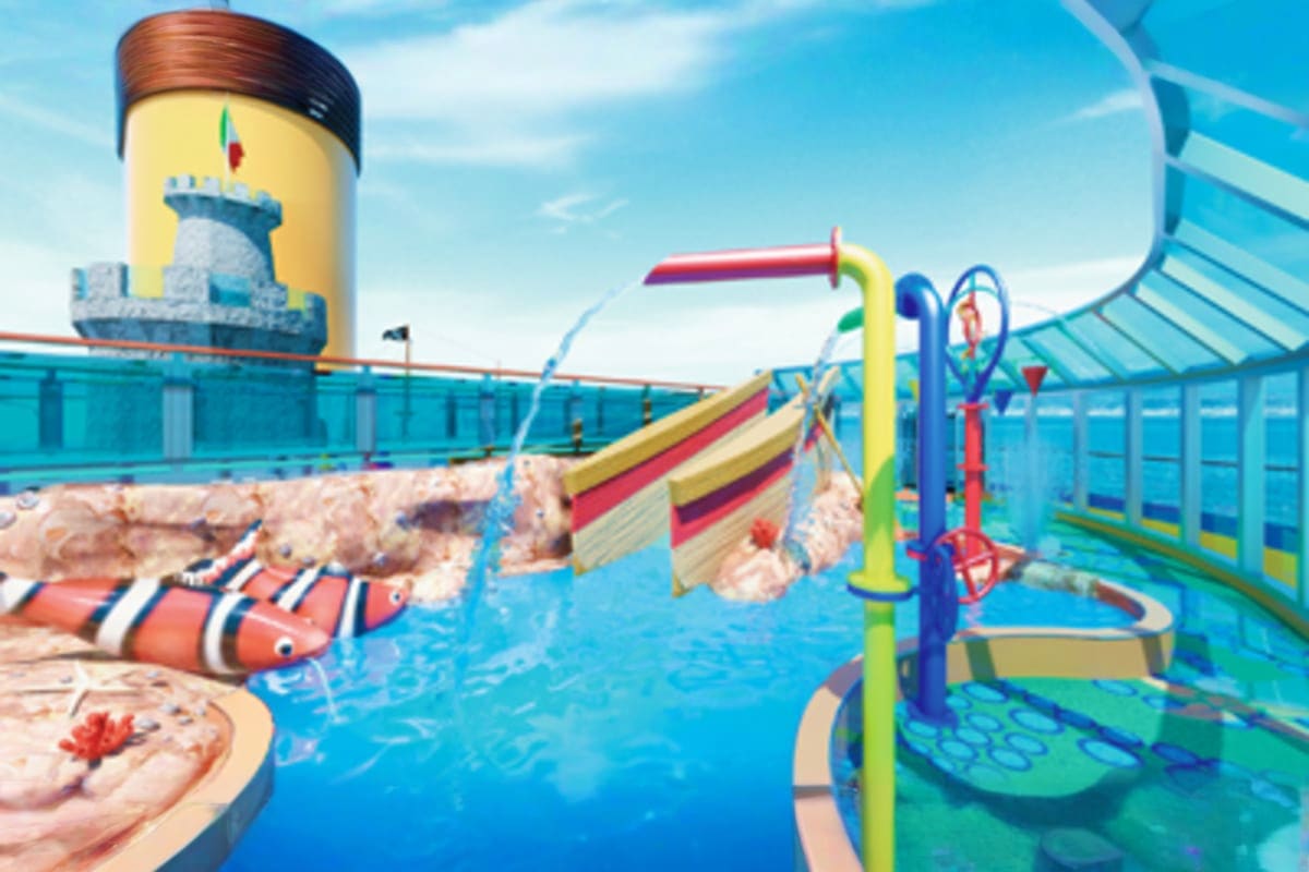 Colorful water park deck on Costa Fascinosa cruise ship featuring slides, splash pools, and yellow lighthouse-themed tower st