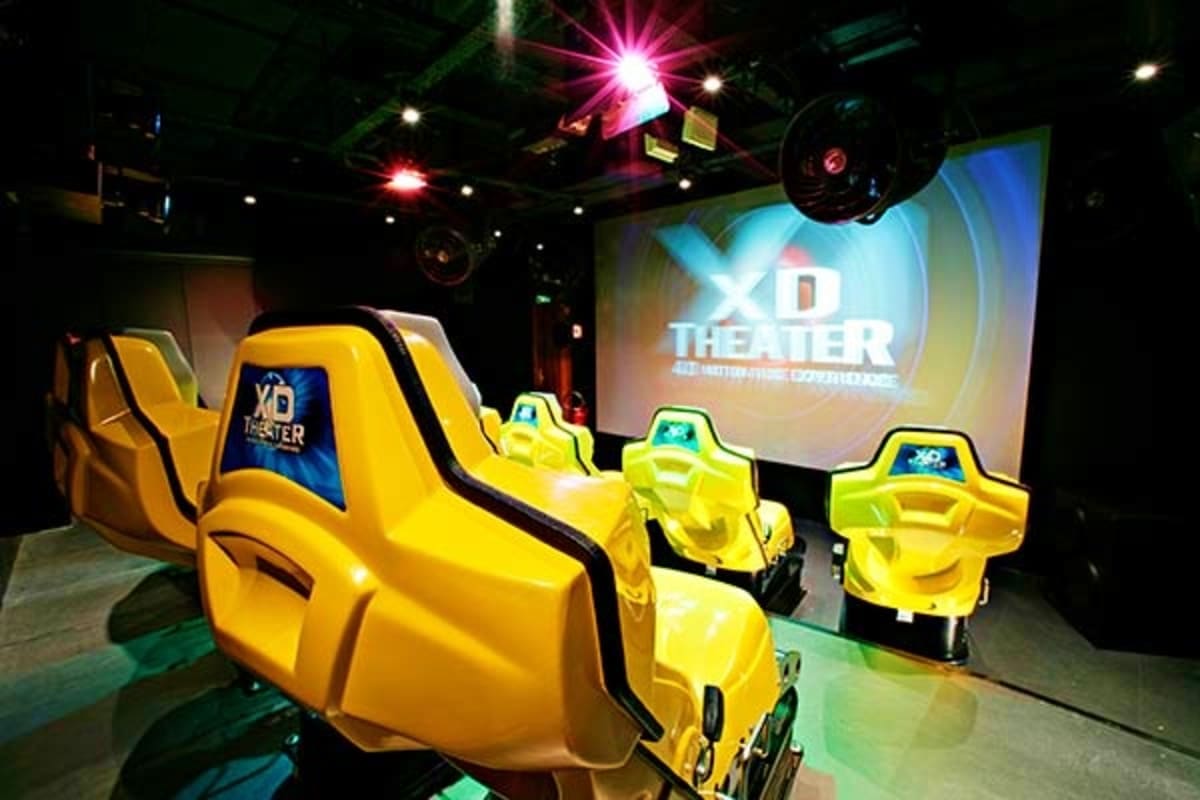 XD Theater motion simulator ride with yellow seats and motion-based vehicle pods inside modern entertainment venue