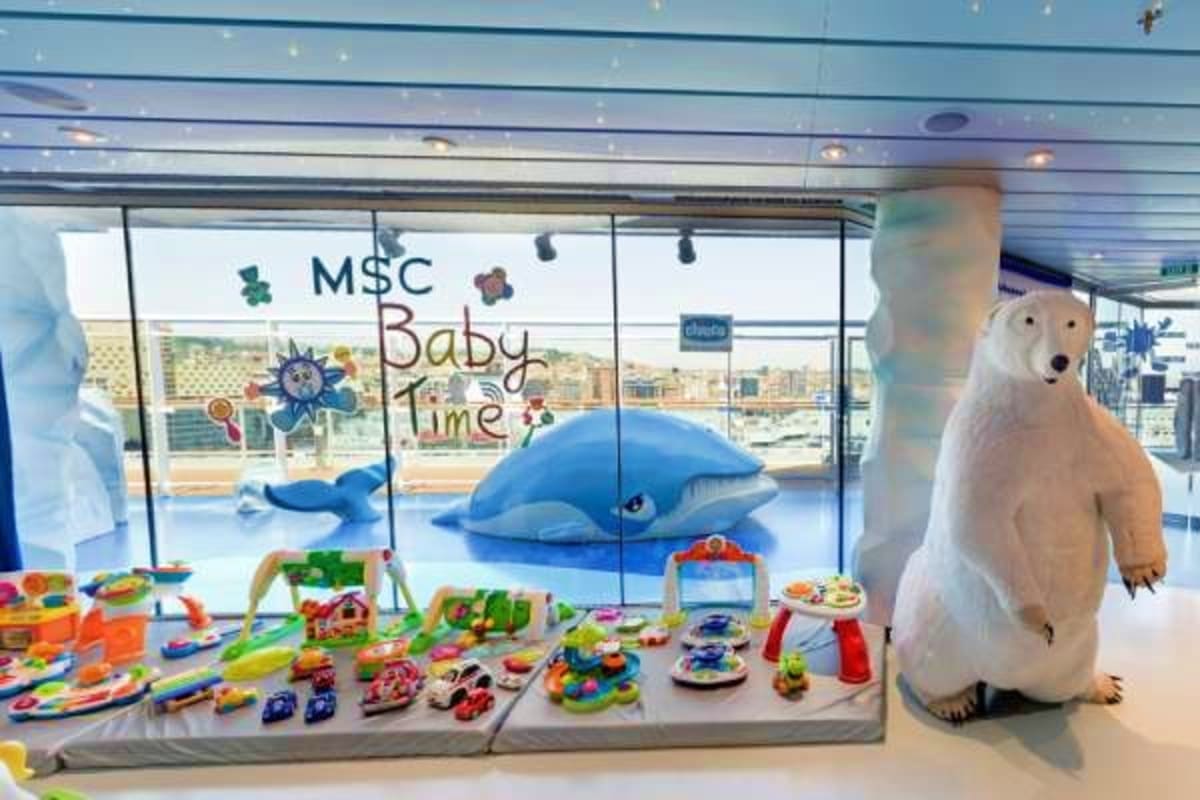 MSC Baby Time play area with blue whale display, colorful toys, and polar bear mascot on MSC Fantasia cruise ship
