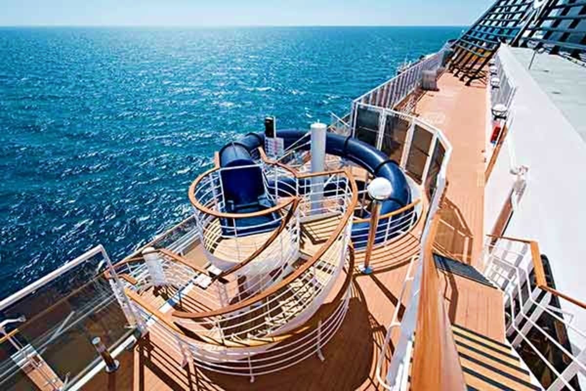 Cruise ship deck with lounge chairs and ocean view overlooking blue Mediterranean waters during daytime