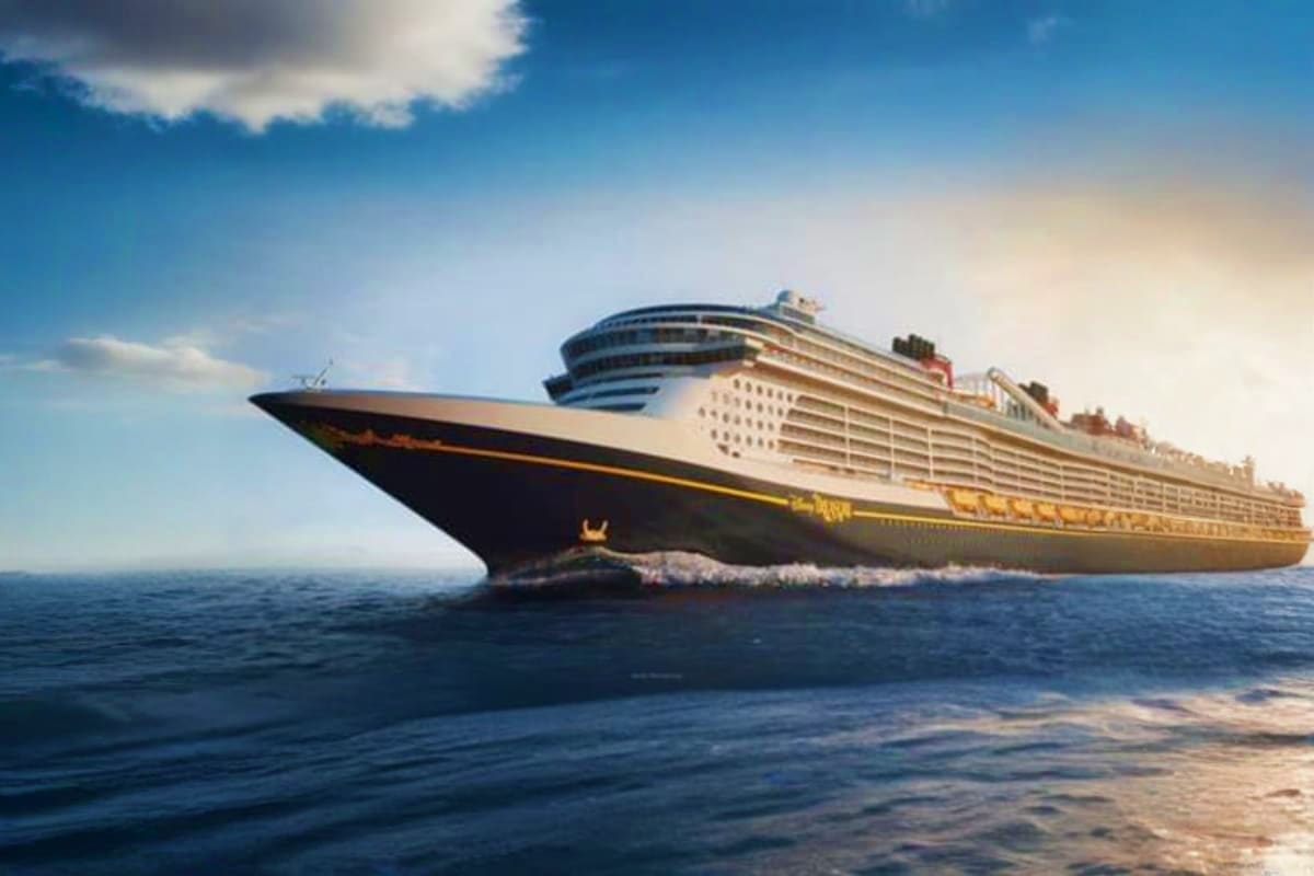 Disney Adventure Disney Magic in Asia Large luxury cruise ship with black hull and white superstructure sailing on blue ocean under clear sky