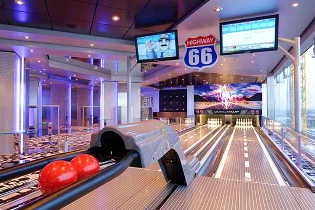 Modern bowling alley with Highway 66 sign, multiple lanes, red bowling balls, and purple ambient lighting on a cruise ship.