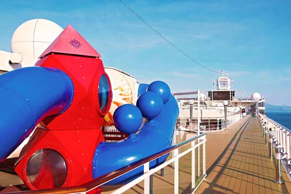 Red rocket slide and blue octopus water park attractions on MSC Magnifica cruise ship deck with ocean view
