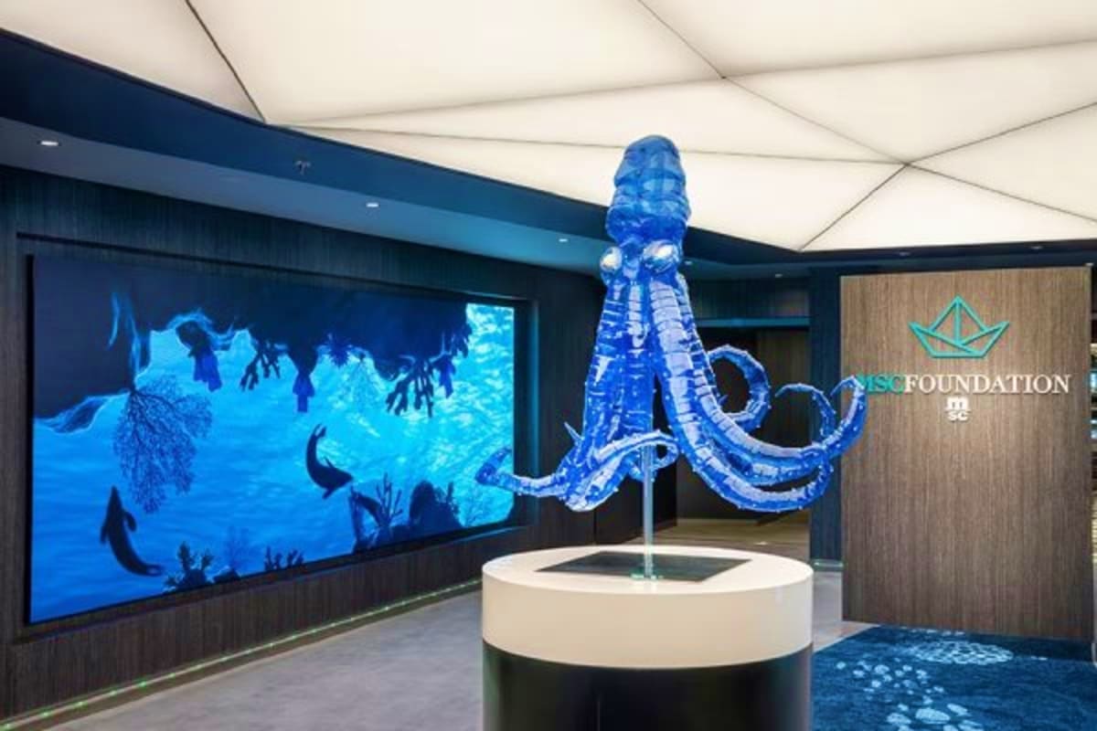 Interactive octopus sculpture display in modern cruise ship interior with ocean-themed video wall and MSC Foundation branding