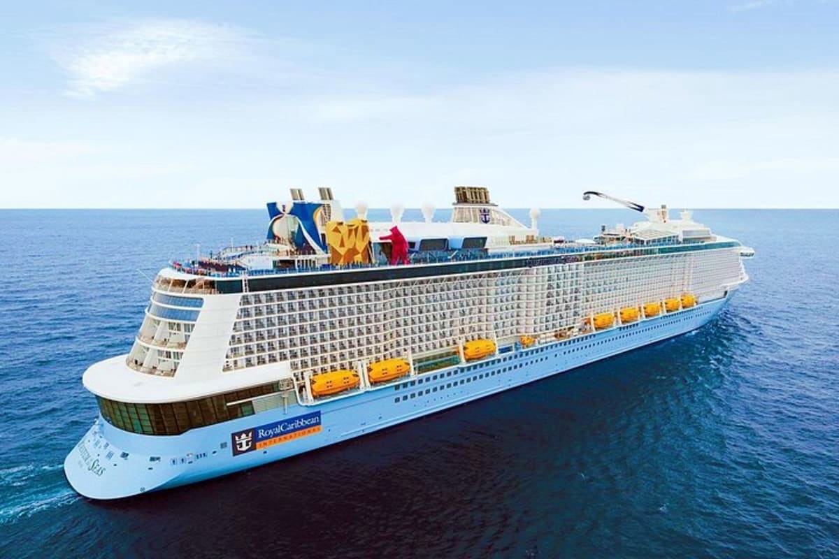 Western Mediterranean Cruise Royal Caribbean cruise ship with blue hull and colorful lifeboats sailing on open ocean waters under clear sky
