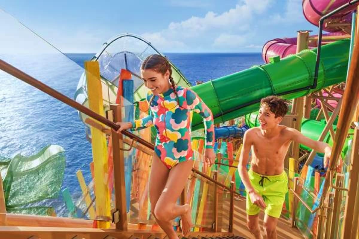 Children enjoying waterslides and ocean views on a cruise ship deck overlooking the Mediterranean Sea