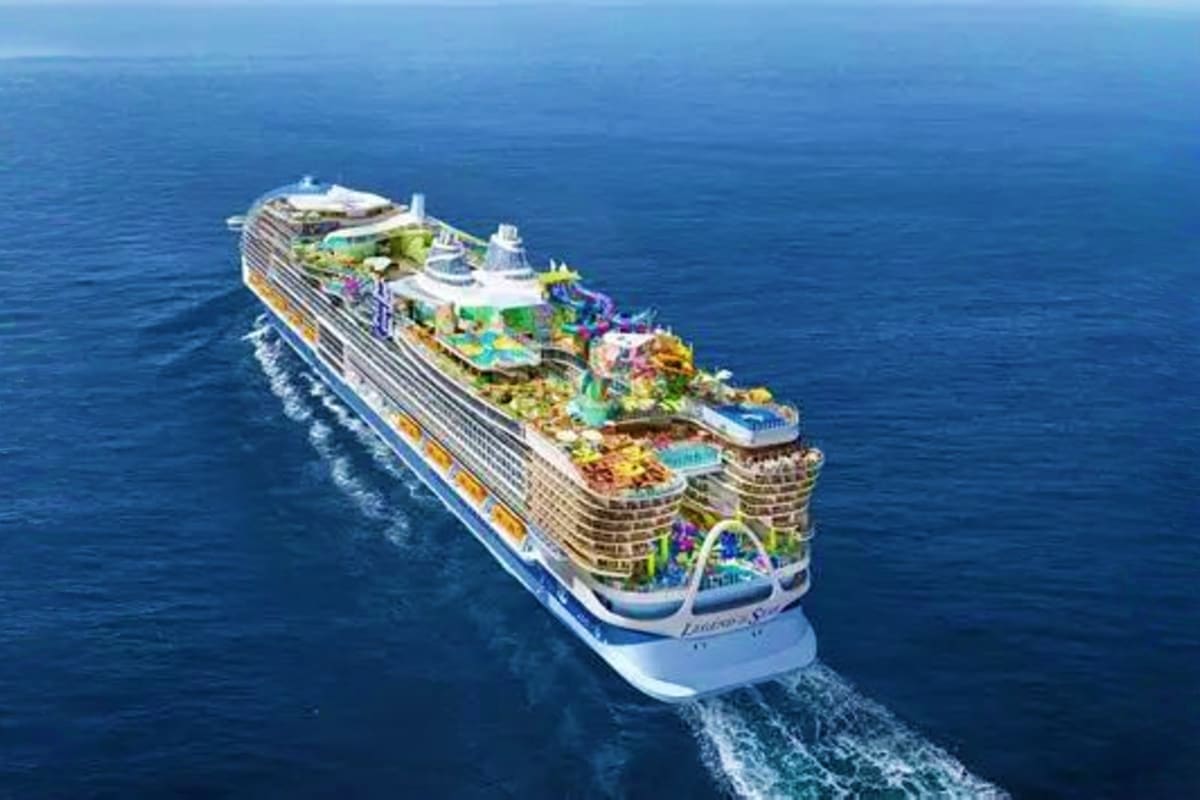 Aerial view of Royal Caribbean Legend of the Seas cruise ship sailing on blue ocean water with multiple deck levels and ameni