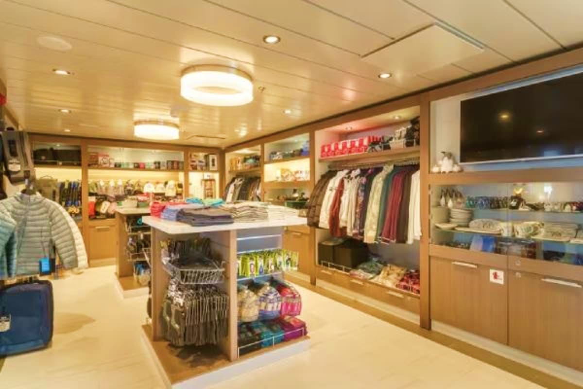 Arctic Expedition with Quark Expeditions aboard Ocean Explorer Modern clothing and retail shop interior aboard cruise ship with wood cabinetry, hanging garments, and organized merchandise