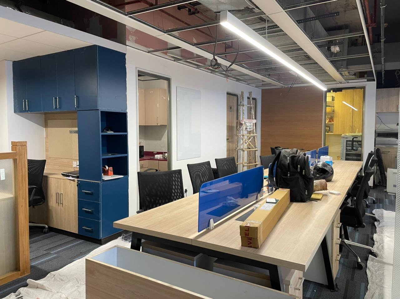 Knauf office open workstation zone with linear desks and blue dividers