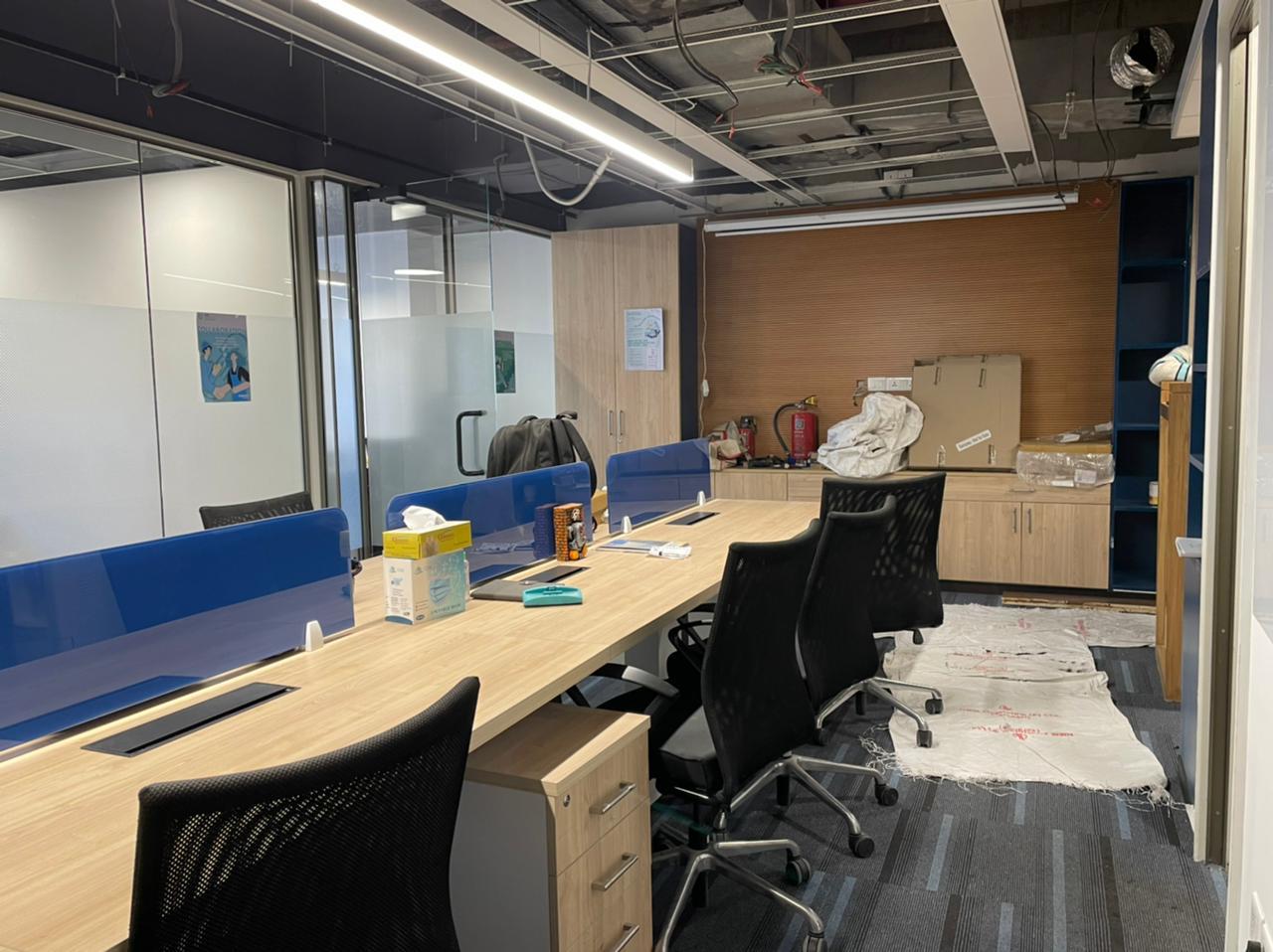 Knauf office interior with warm wood, neutrals, and bold blue accents