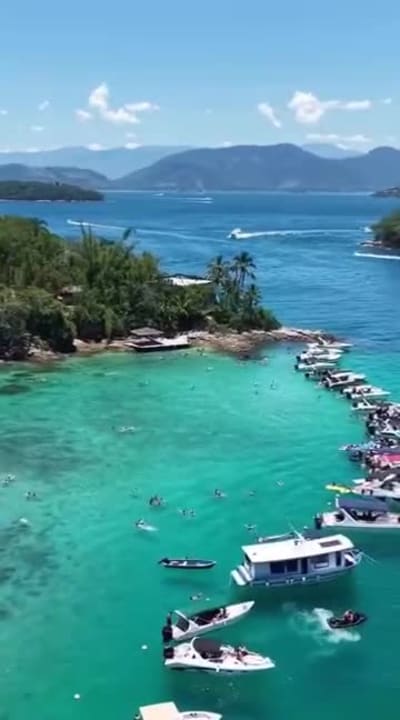 Lagoa Azul, em Ilha Grande, com lanchas ancoradas na água turquesa, vista de drone