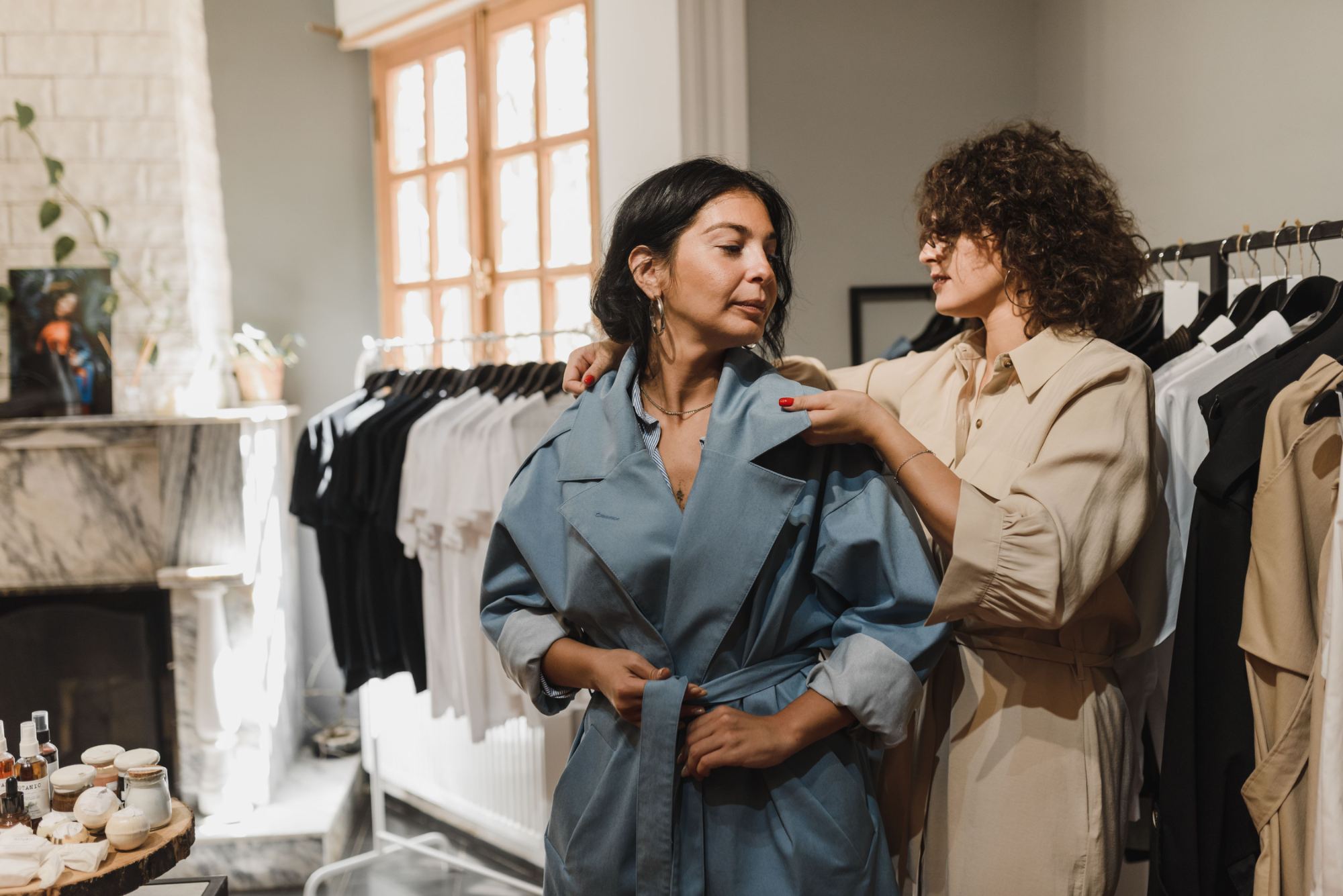 A stylist helping a client into a piece at Empress Melbourne — what we offer