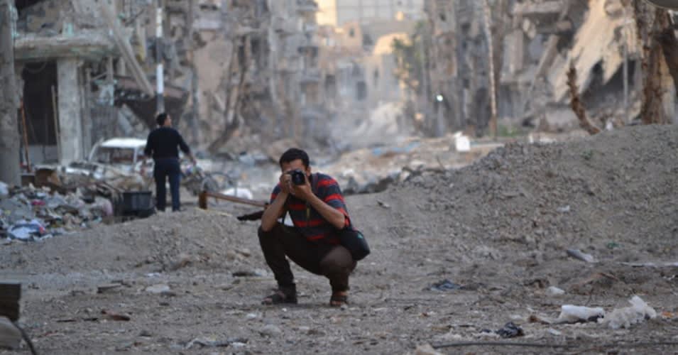Photojournalist documenting in conflict zone