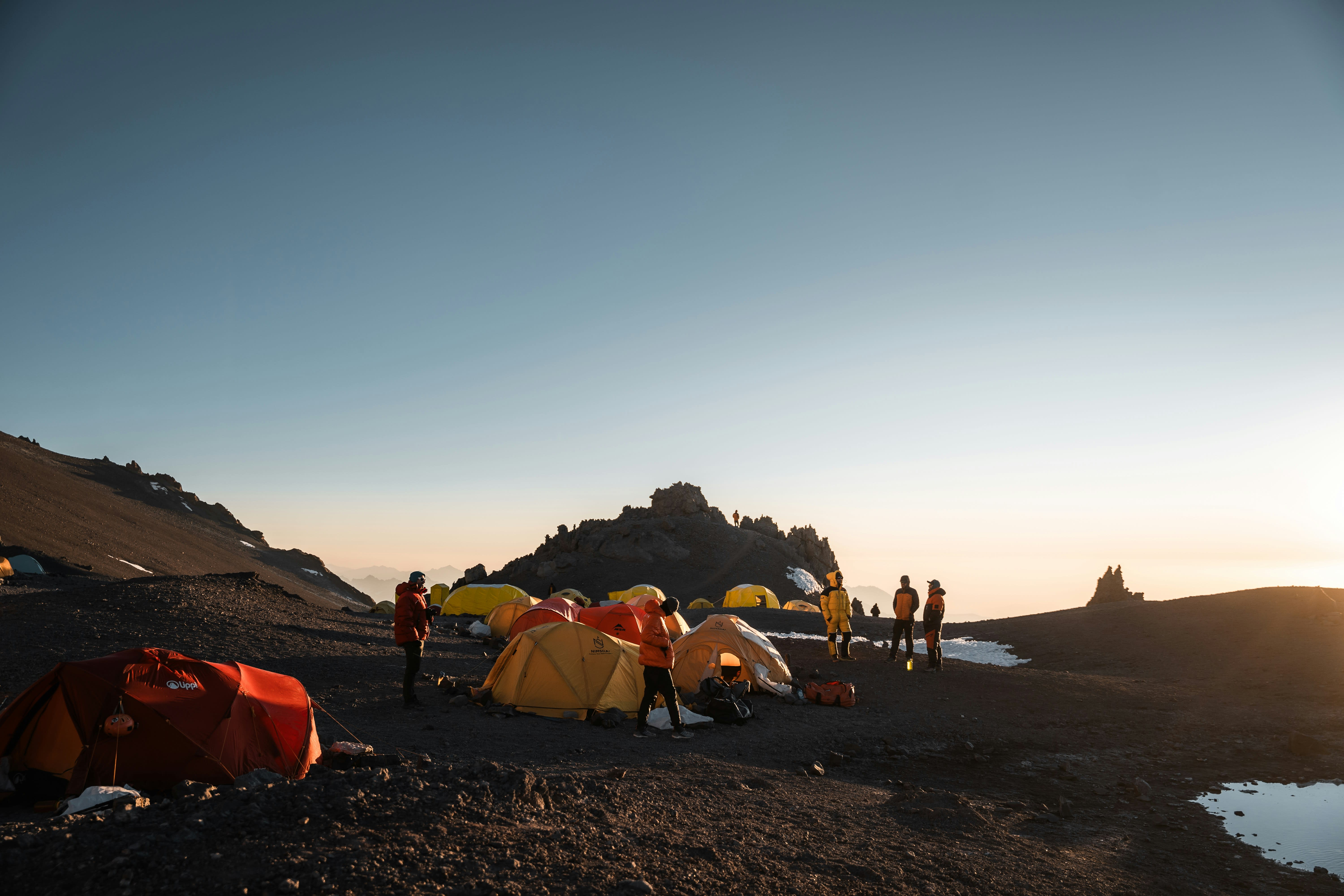 Scientific expedition camp with tents in a remote mountain setting