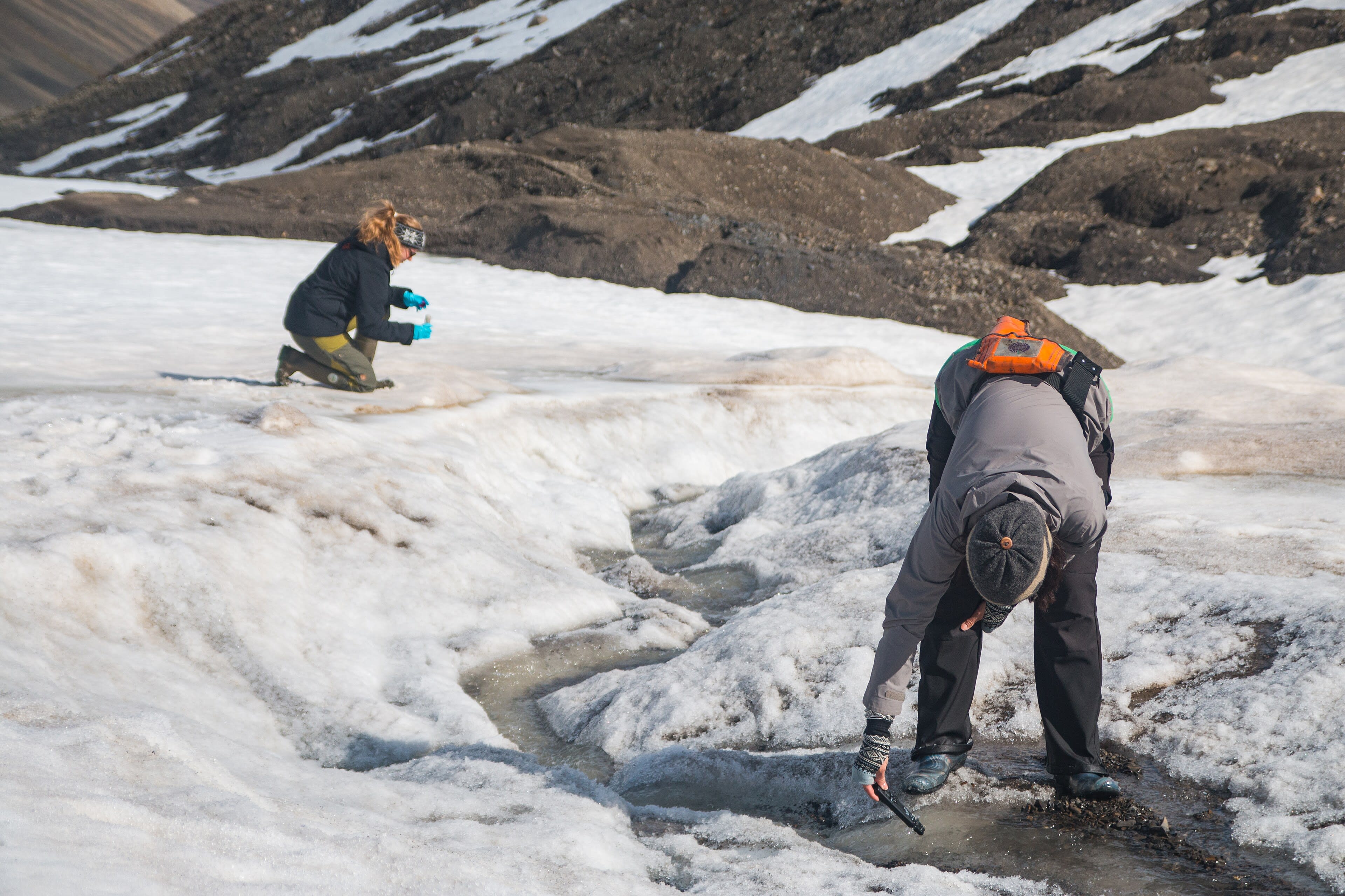 Field researchers collecting samples in a remote landscape