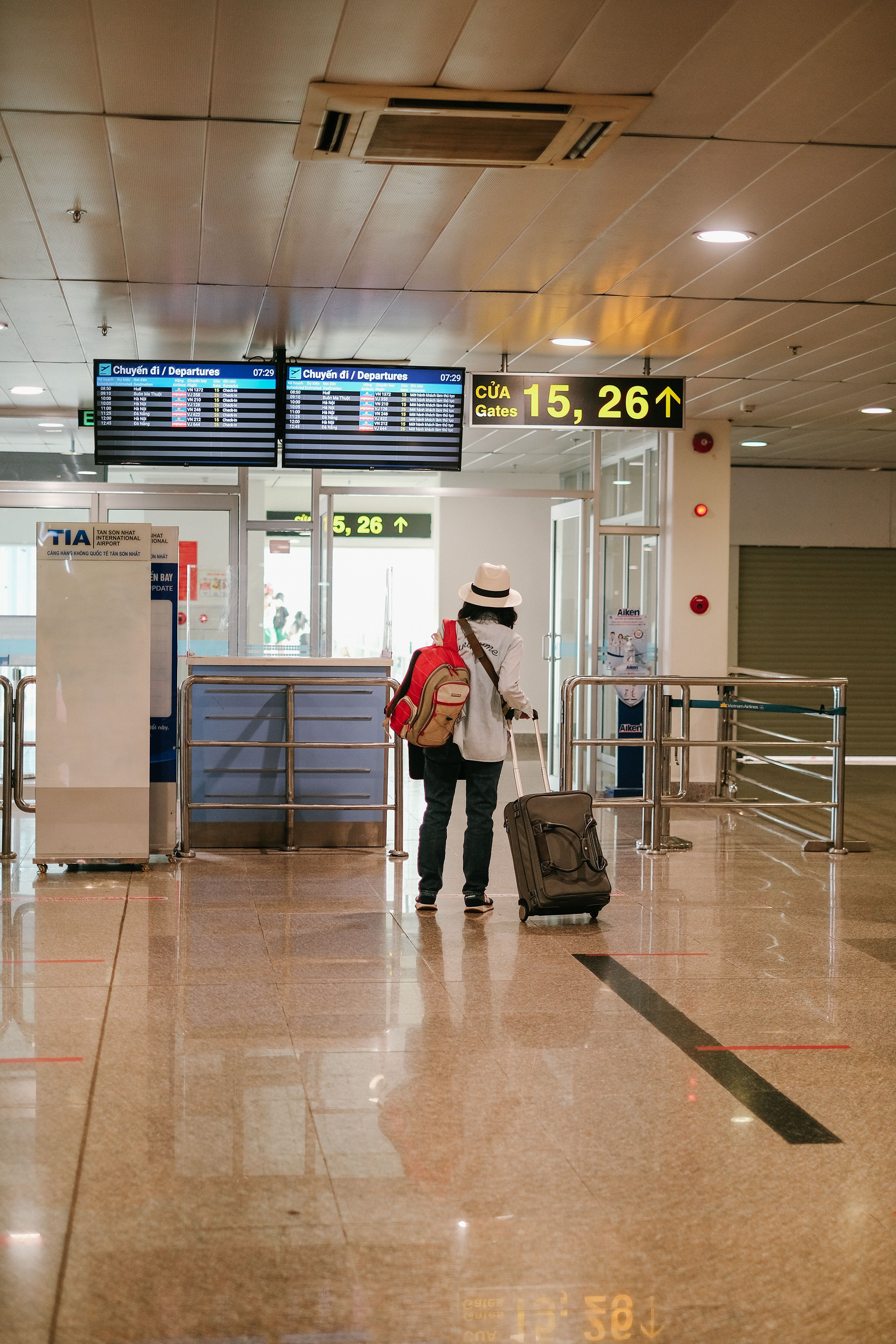 Lone professional traveller checking a map near airport departures