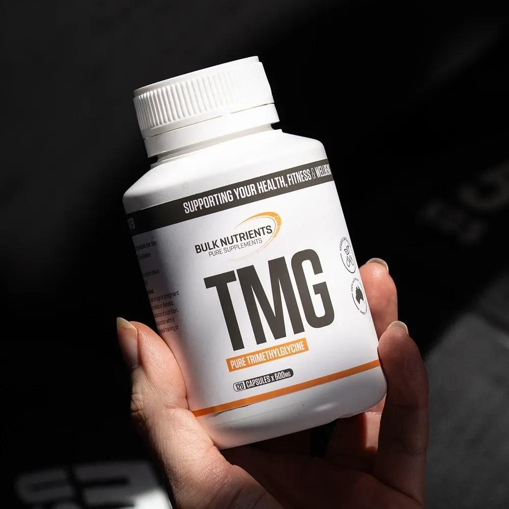 TMG Capsules being held in left hand