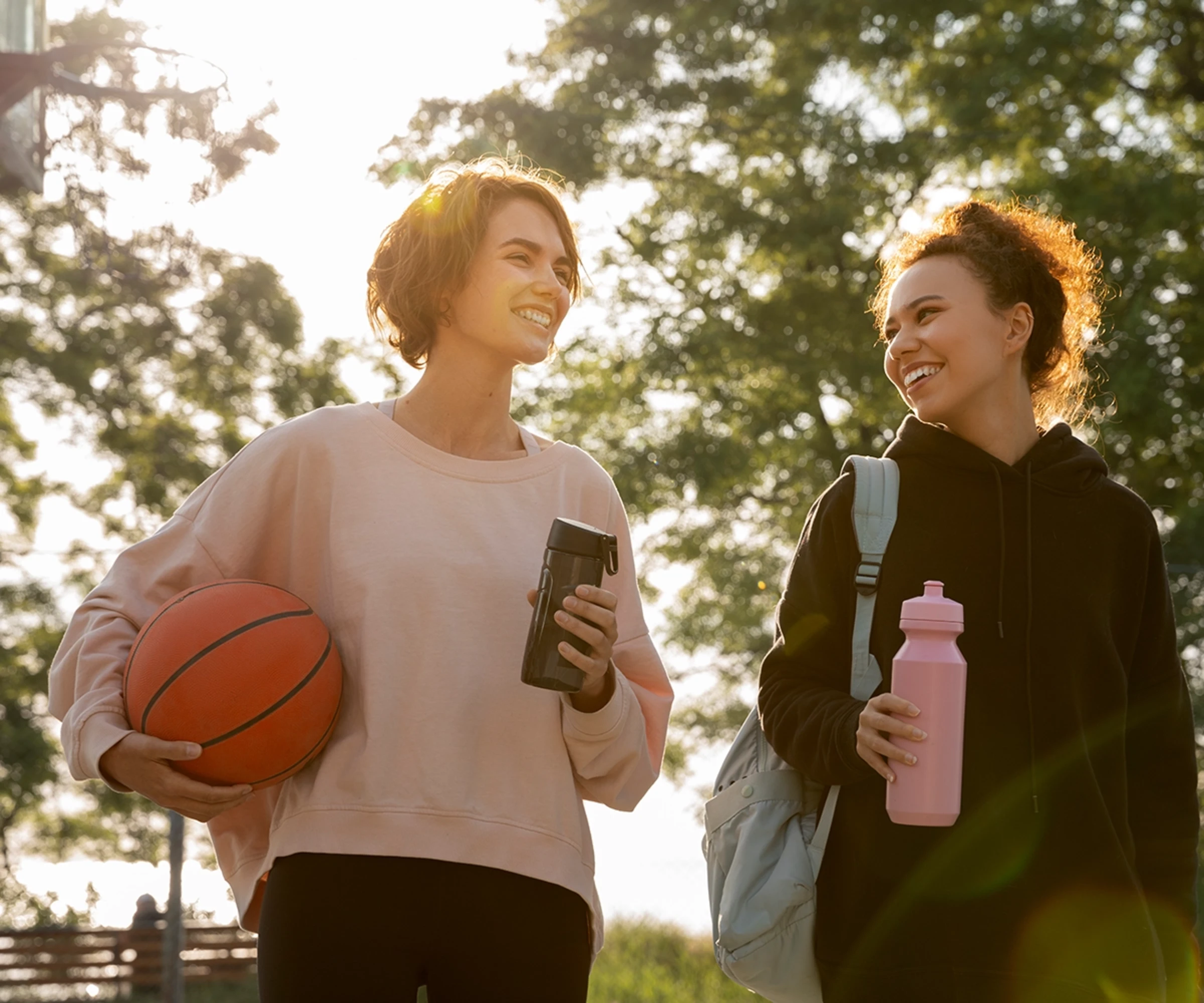 Two women just played some basketball and now walking home