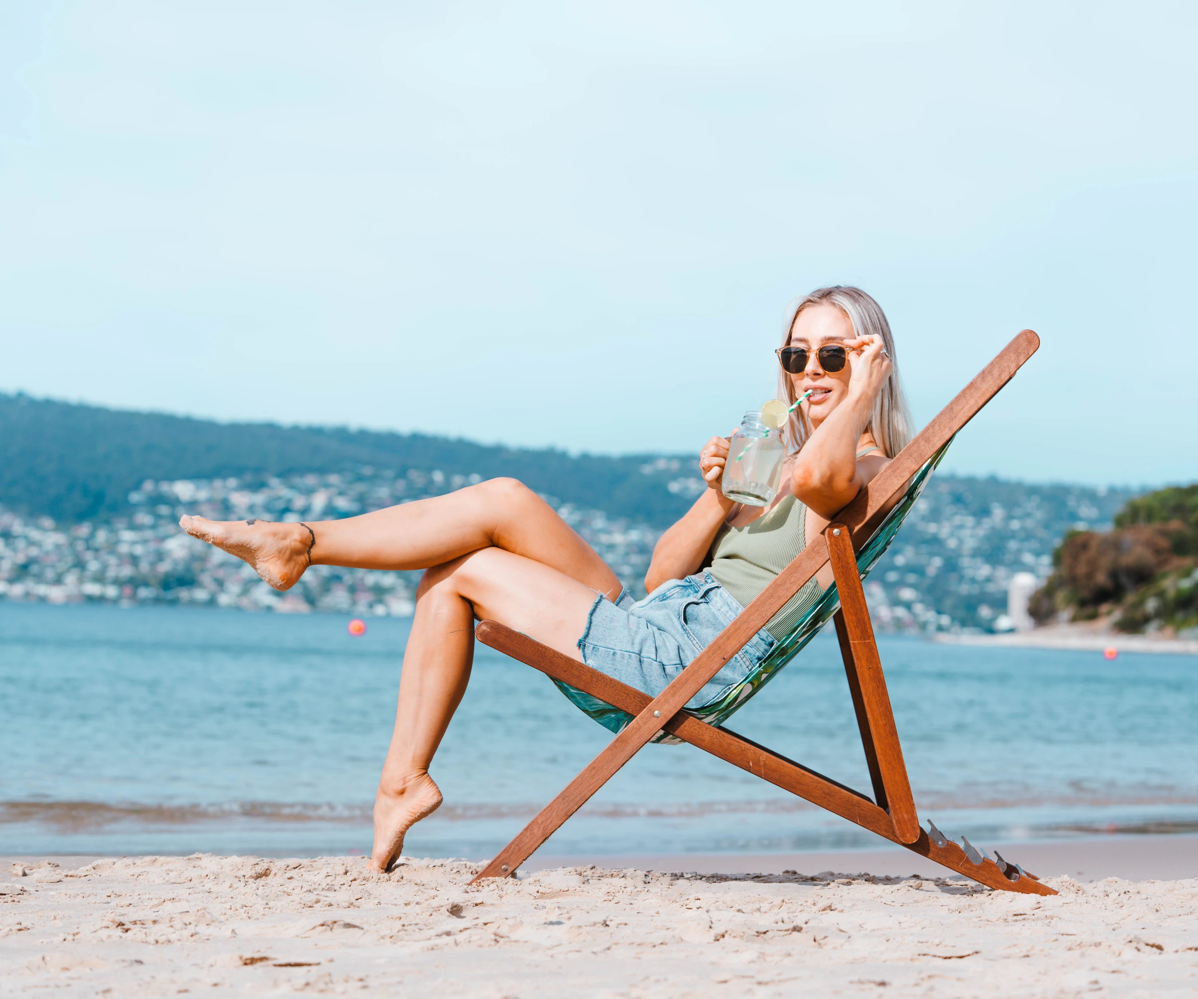 Chelsea Reid on the beach in a deck chair