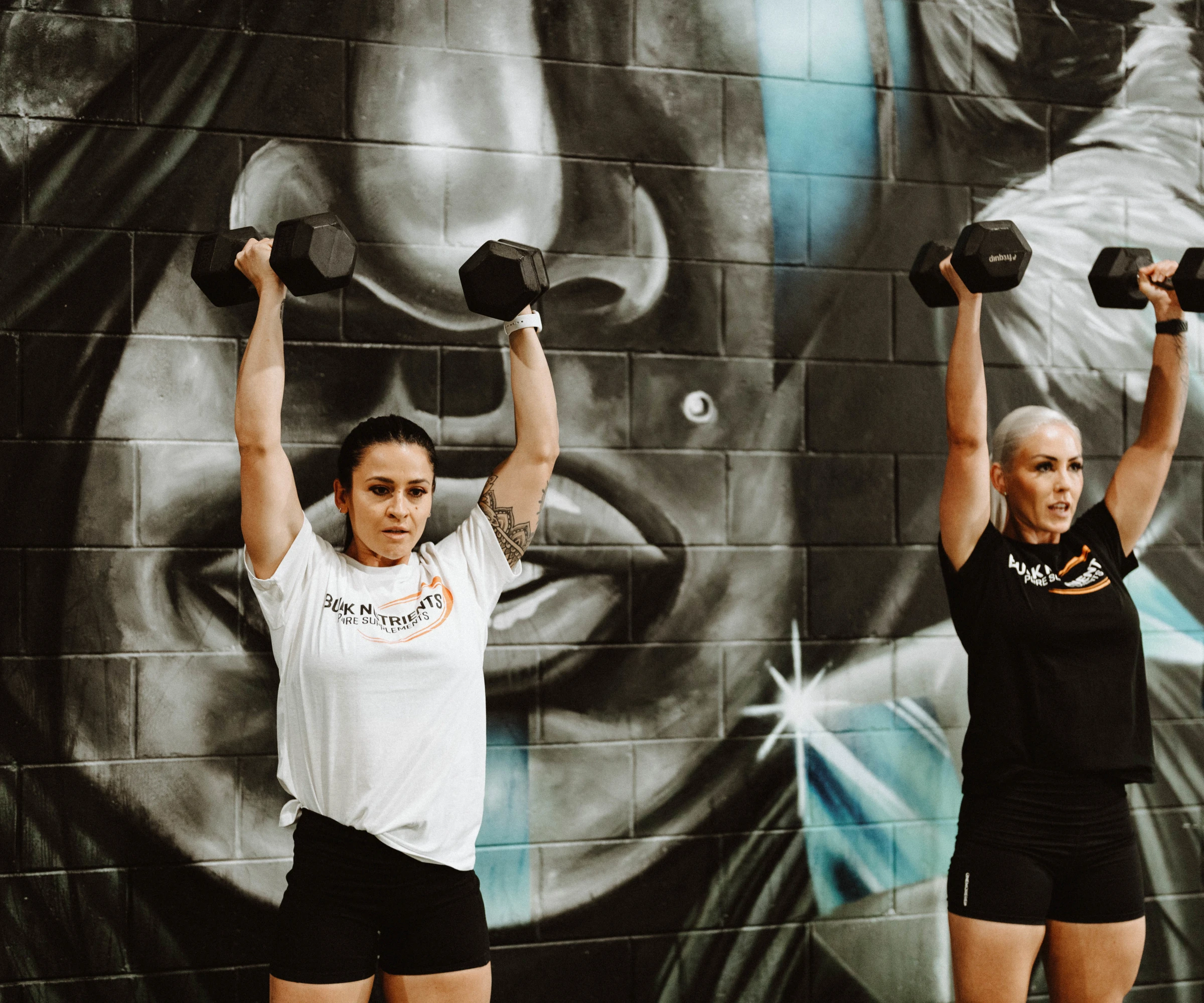 Bulk Nutrients Ambassadors Tammie Sarkozy and Tarran Lee in the gym with weights