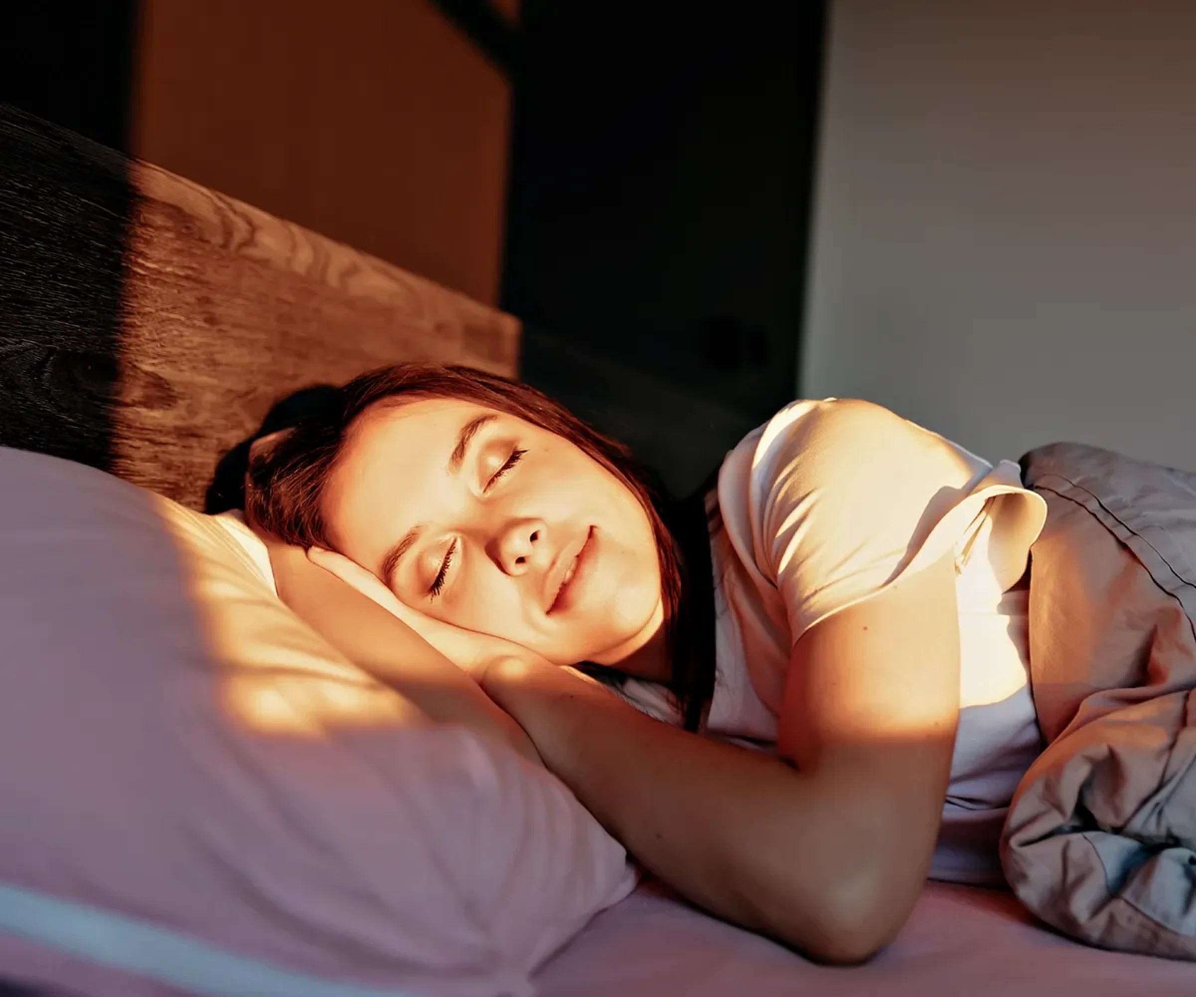 Person im bed sleeping with the afternoon sun