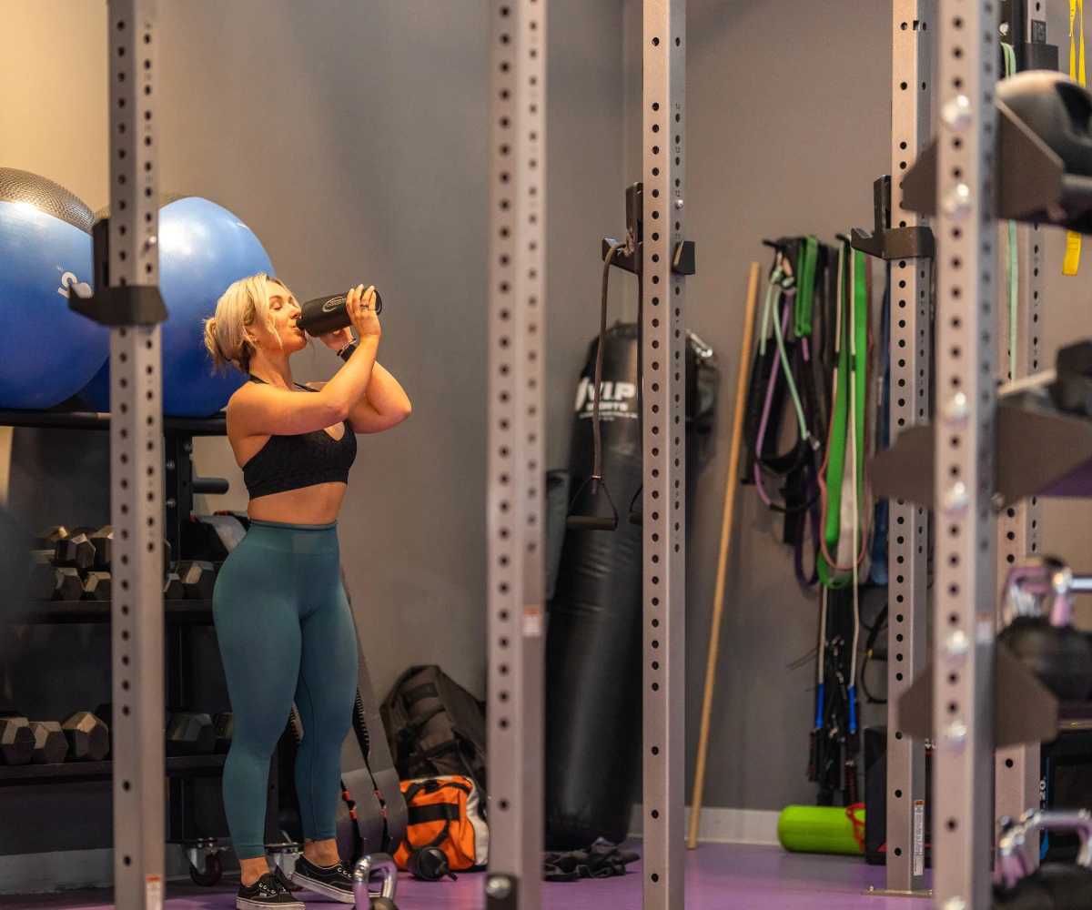 Talia Smith in the gym drinking from a bulk shaker