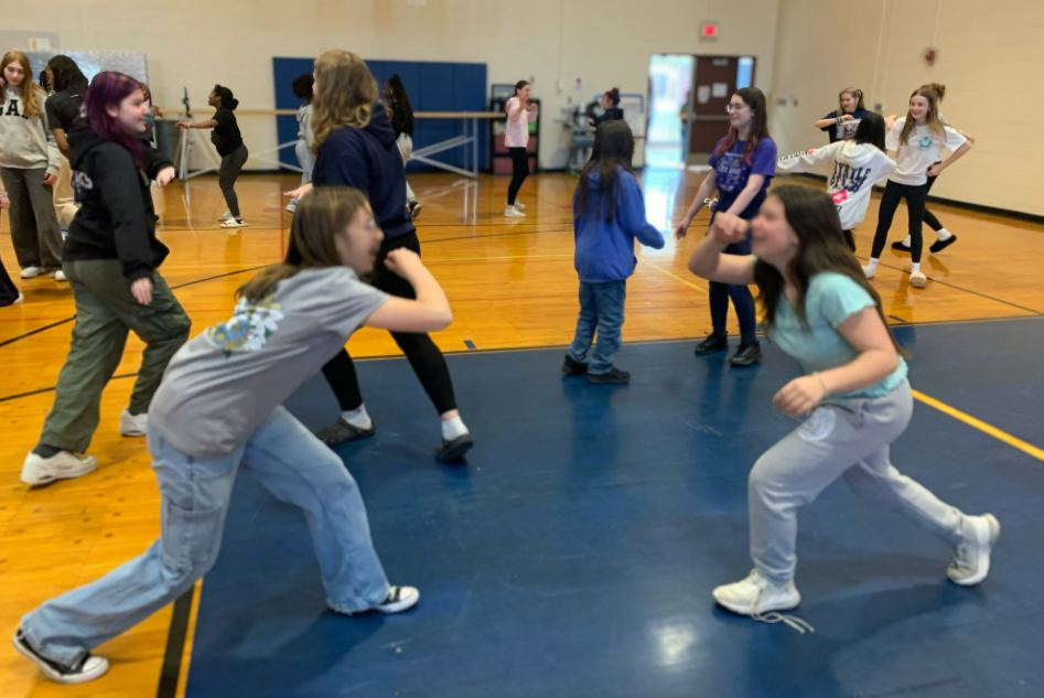 Two people play capoeira
