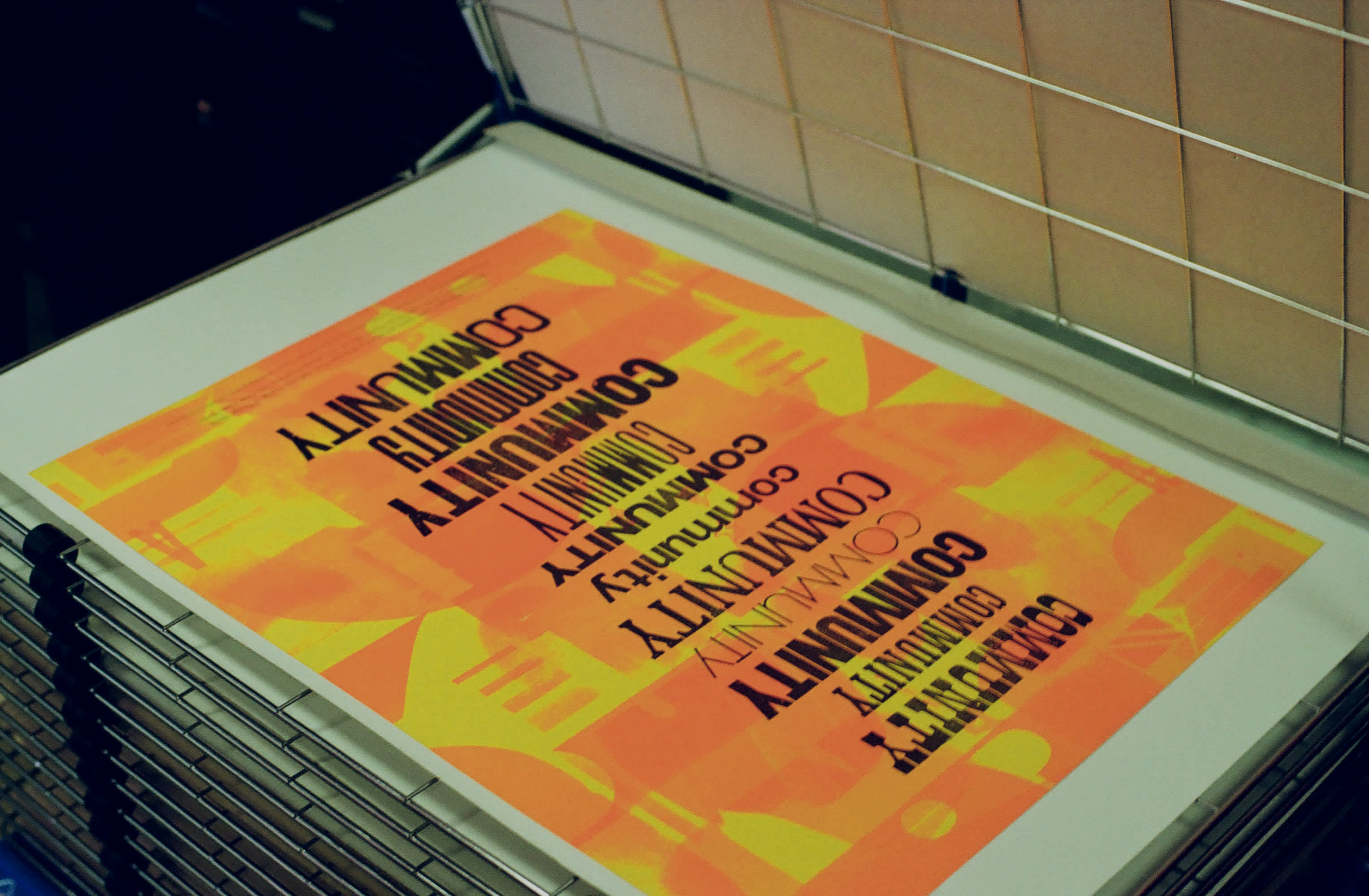 Final poster result: an orange poster background with black type that says 'community' in different fonts, vertically centered.