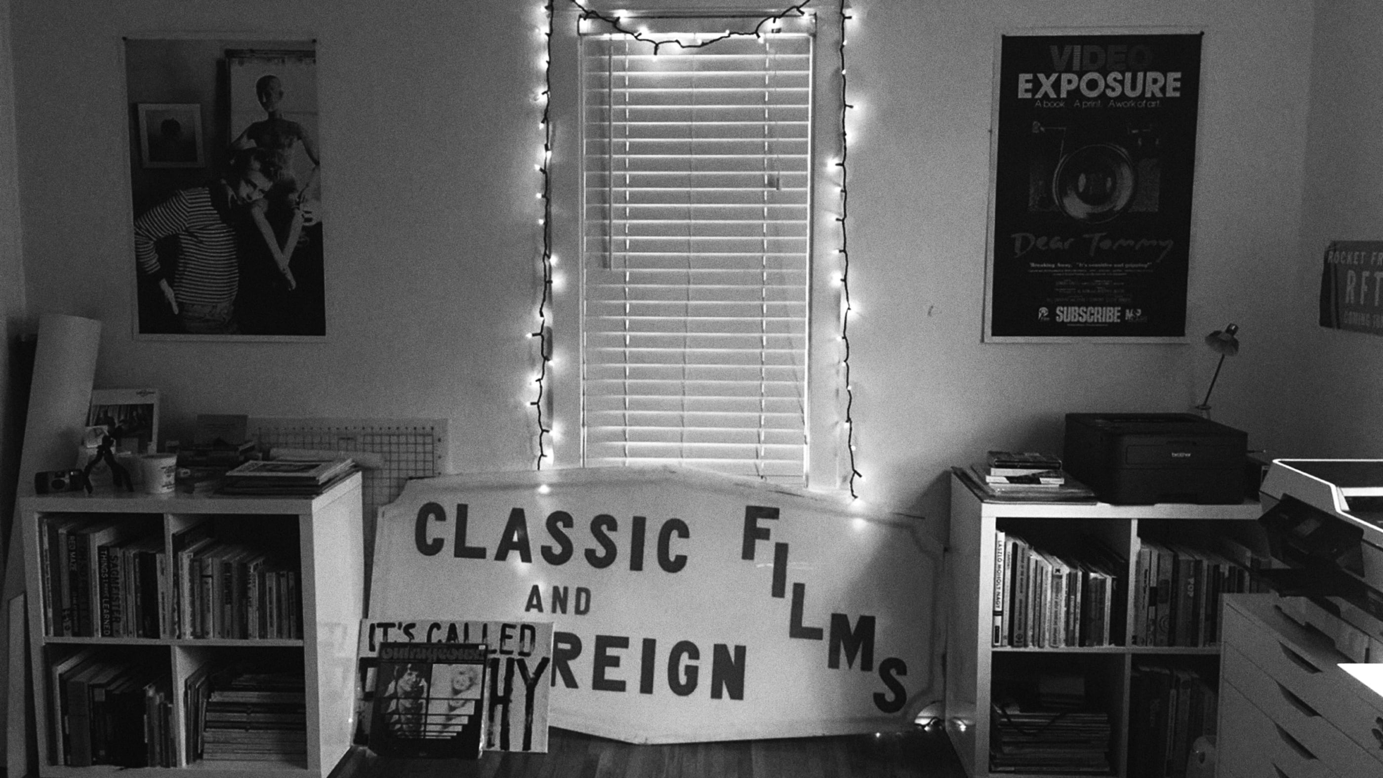 Black and white photo of original lettered signage, front and center, in the design studio
