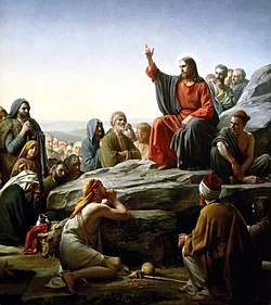 원수도 사랑하라는 예수의 가르침 vs 적대적 기독교 현실 | 모순의 사회학적 분석 군중 앞에서 사랑과 용서를 설파하는 인물이 바위 위에서 말씀을 전하는 고전 회화 장면으로, ‘원수를 사랑하라’는 가르침과 오늘의 적대적 현실 사이의 모순을 성찰하는 글의 주제를 상징적으로 보여 줍니다
