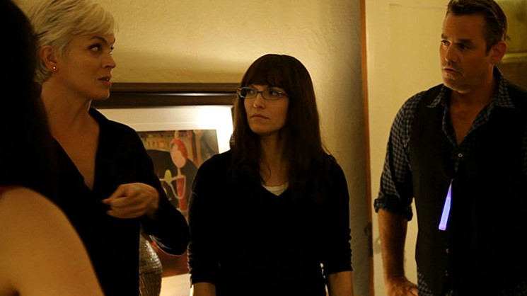 영화 평행이론 도플갱어 살인 코히어런스 스틸컷 - 평행우주 혼란 속 등장인물들이 복도에서 긴장한 표정으로 서로를 의심하며 대치하는 장면