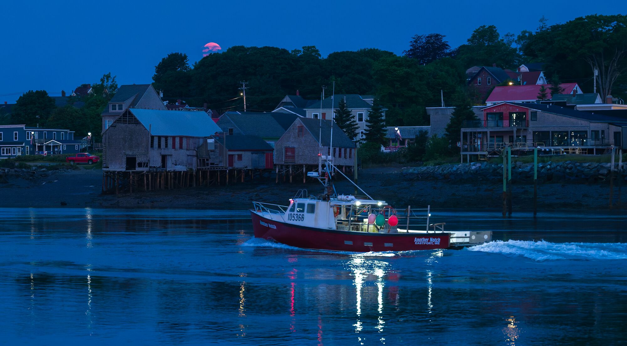 Moonset Over Smokehouses and Fishing Boat