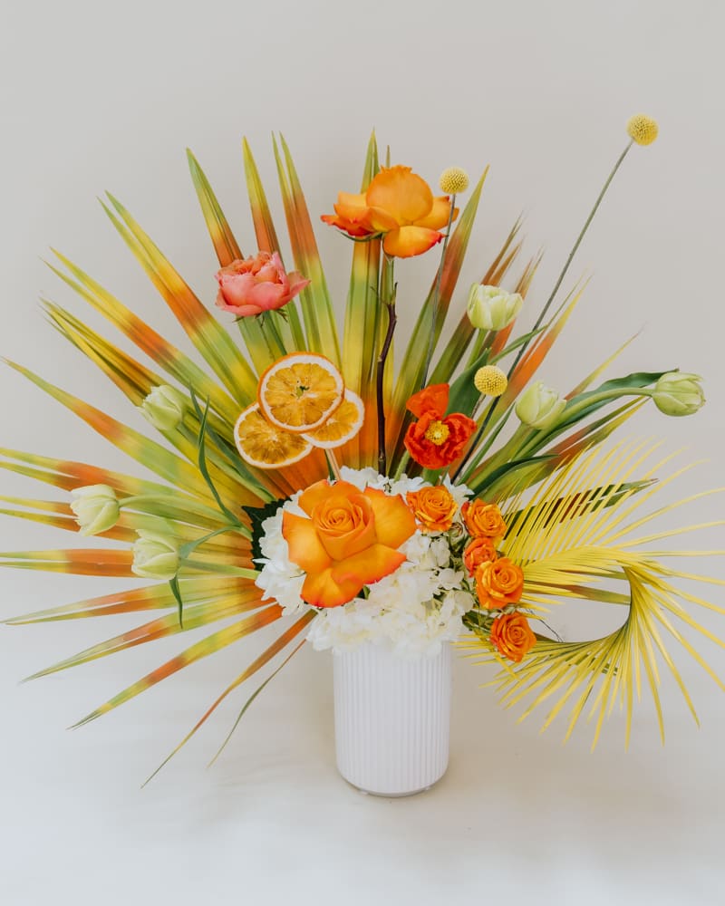 Spray painted green and orange palms, orange slices, fresh blooms