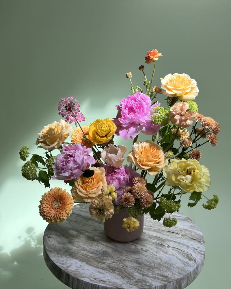 Soft pastel tones of blush pink, buttery yellow, warm apricot