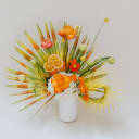 Spray painted green and orange palms, orange slices, fresh blooms