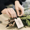 girl un tieing bunches of greenery 