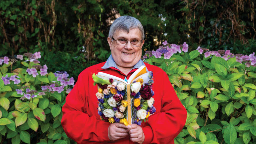 Gayle posing with a book