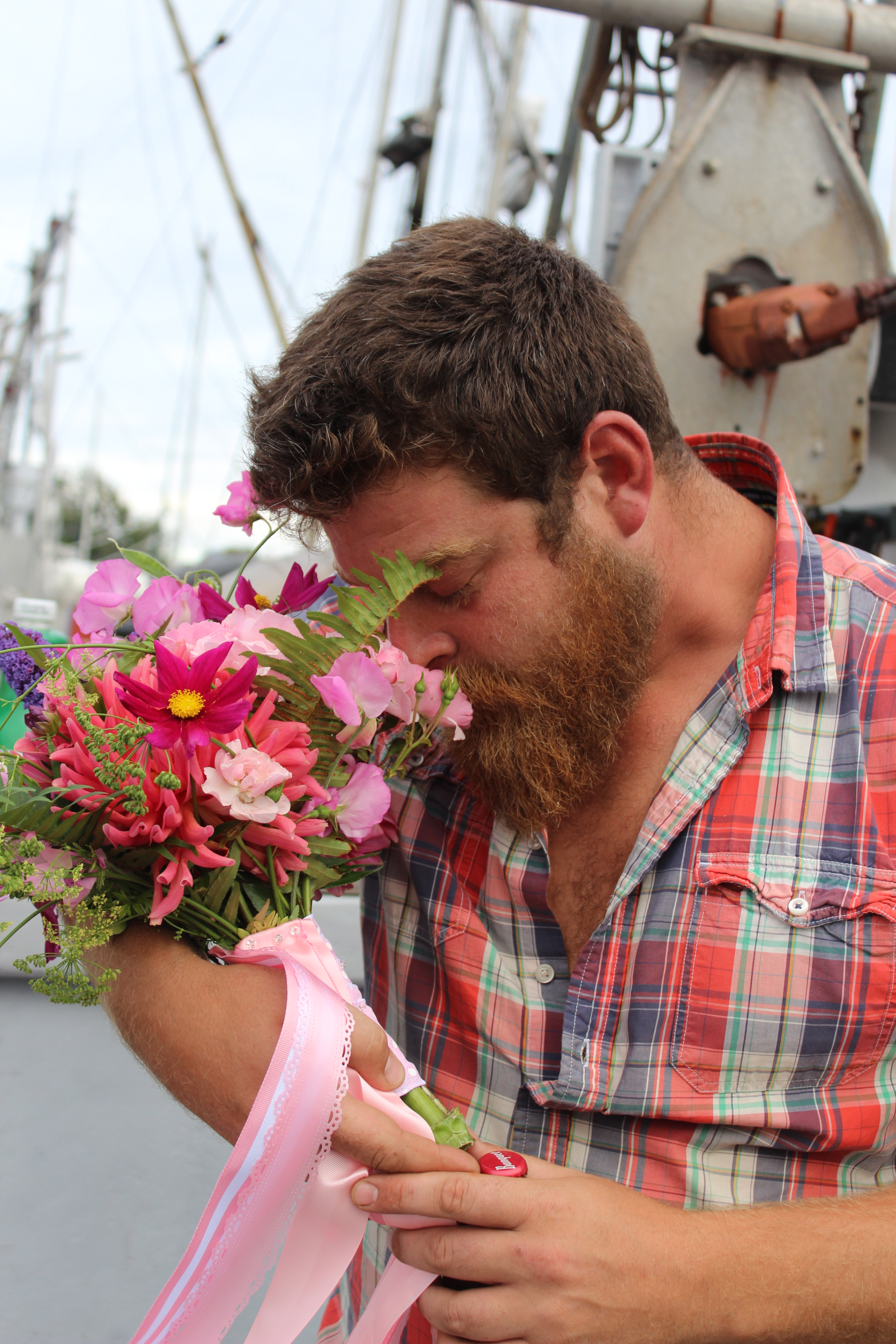 Fisherman smelling a bouquet of flowers.