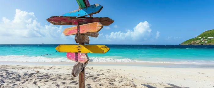 Signpost of Caribbean islands on the beach at St Maarten