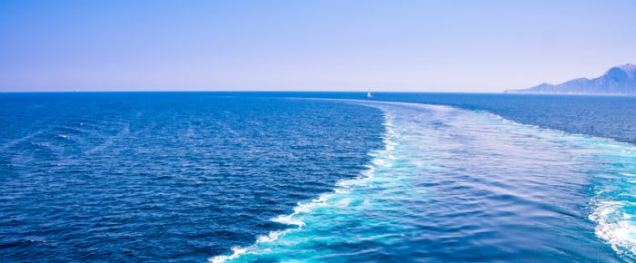 The wake of a boat as seen from the stern of a ship on Mediterranean sea