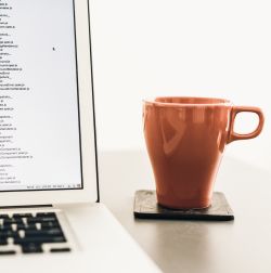 computer and red cup on desk