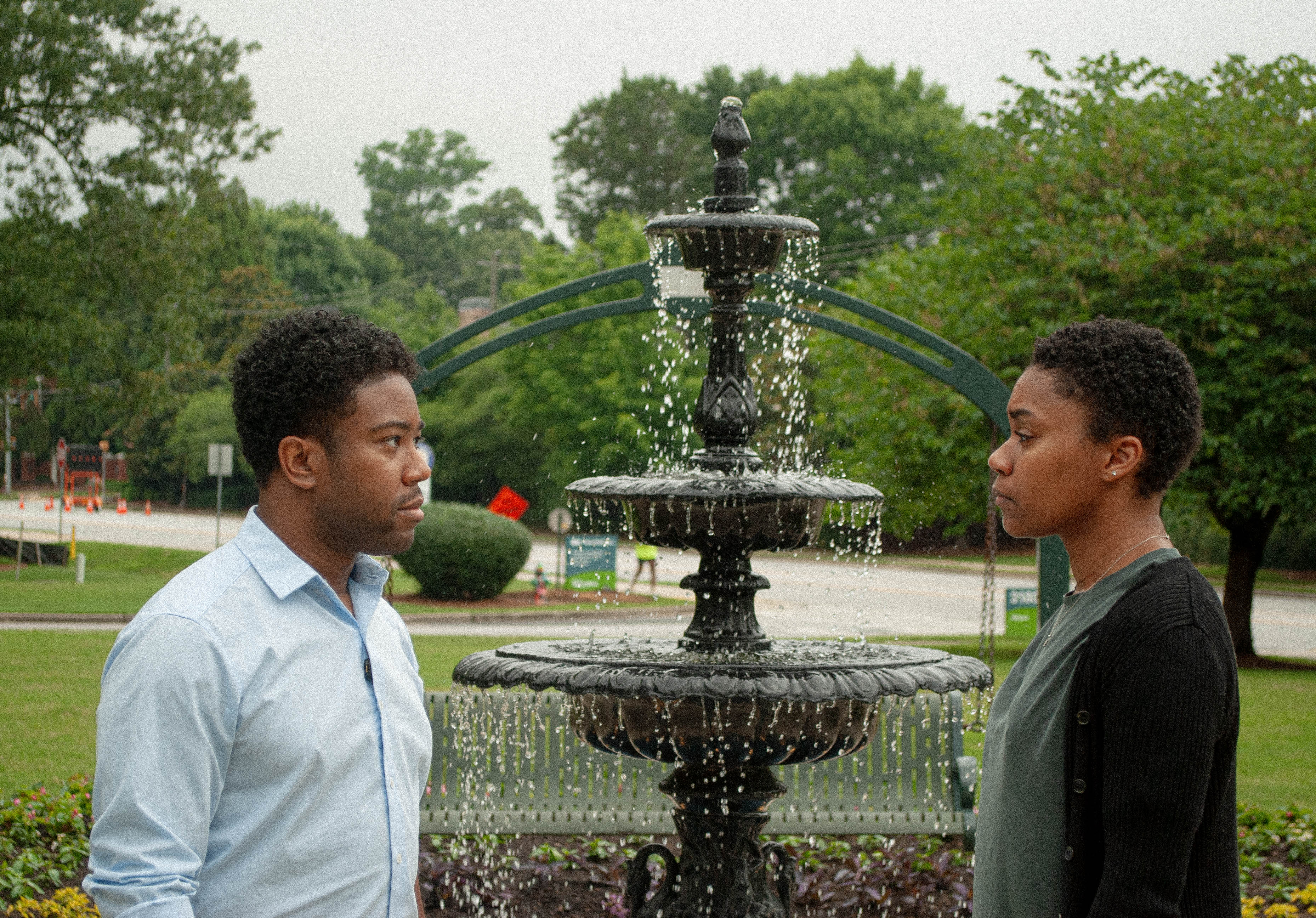 Evan and Natalie face each other across a fountain — Pivot
