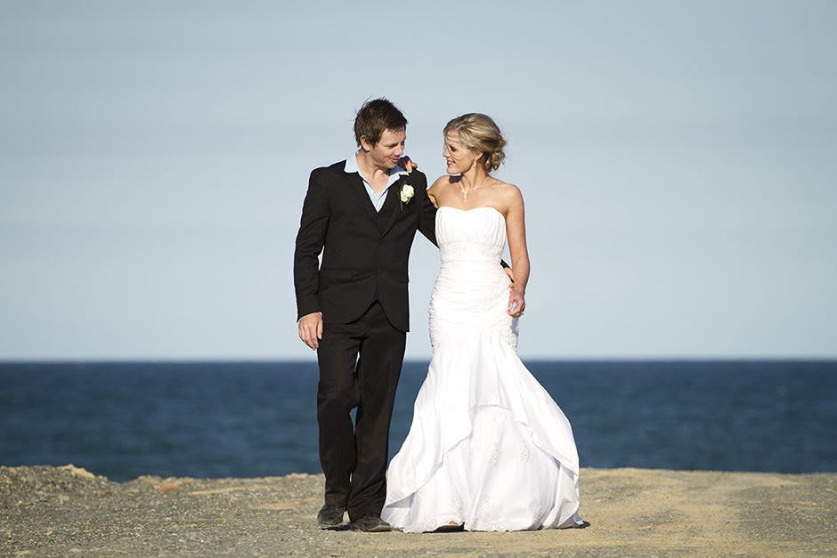wedding couple walking on the beach