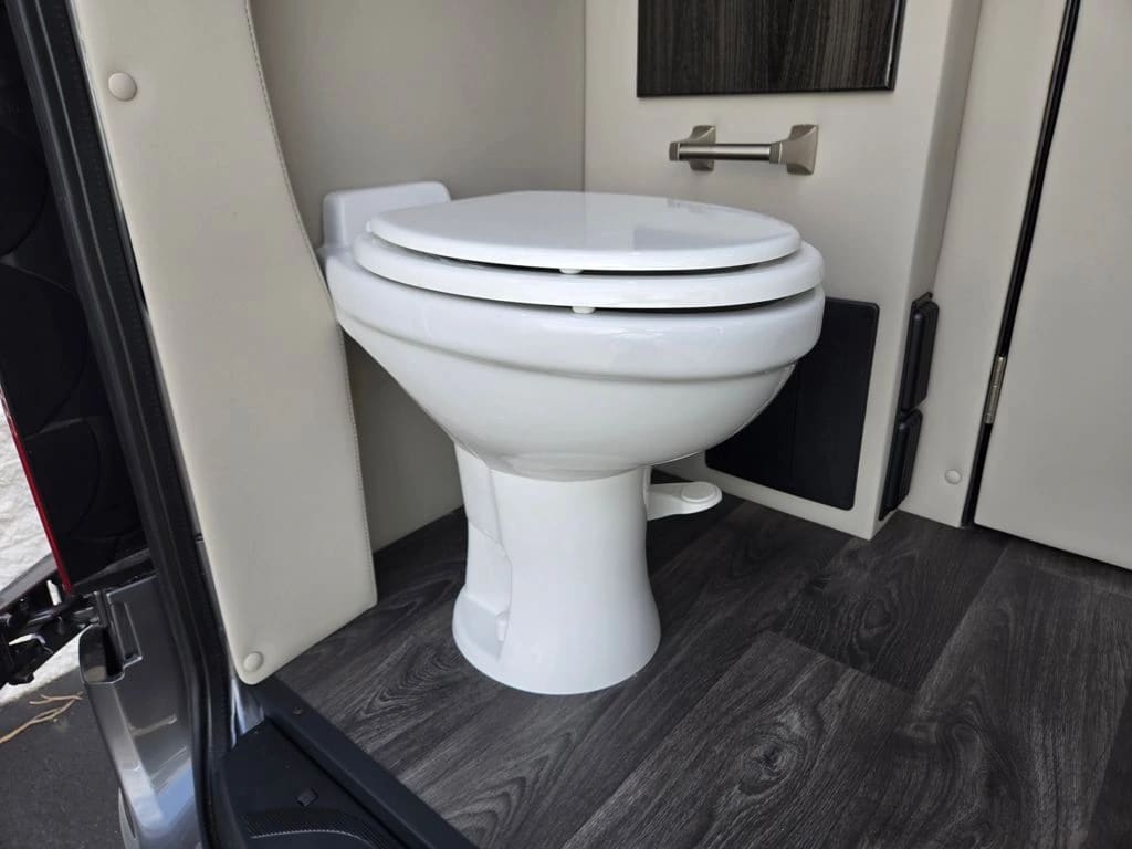 Mercedes Sprinter van bathroom with toilet, sink, and vanity
