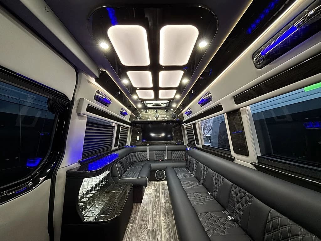 Dark Sprinter lounge seating beside an illuminated glassware cabinet