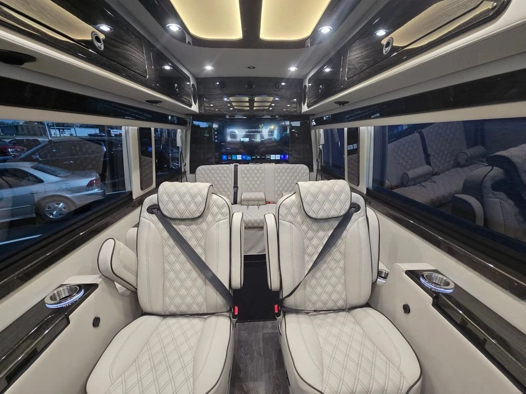 Two light-colored Sprinter seats with additional seating behind them