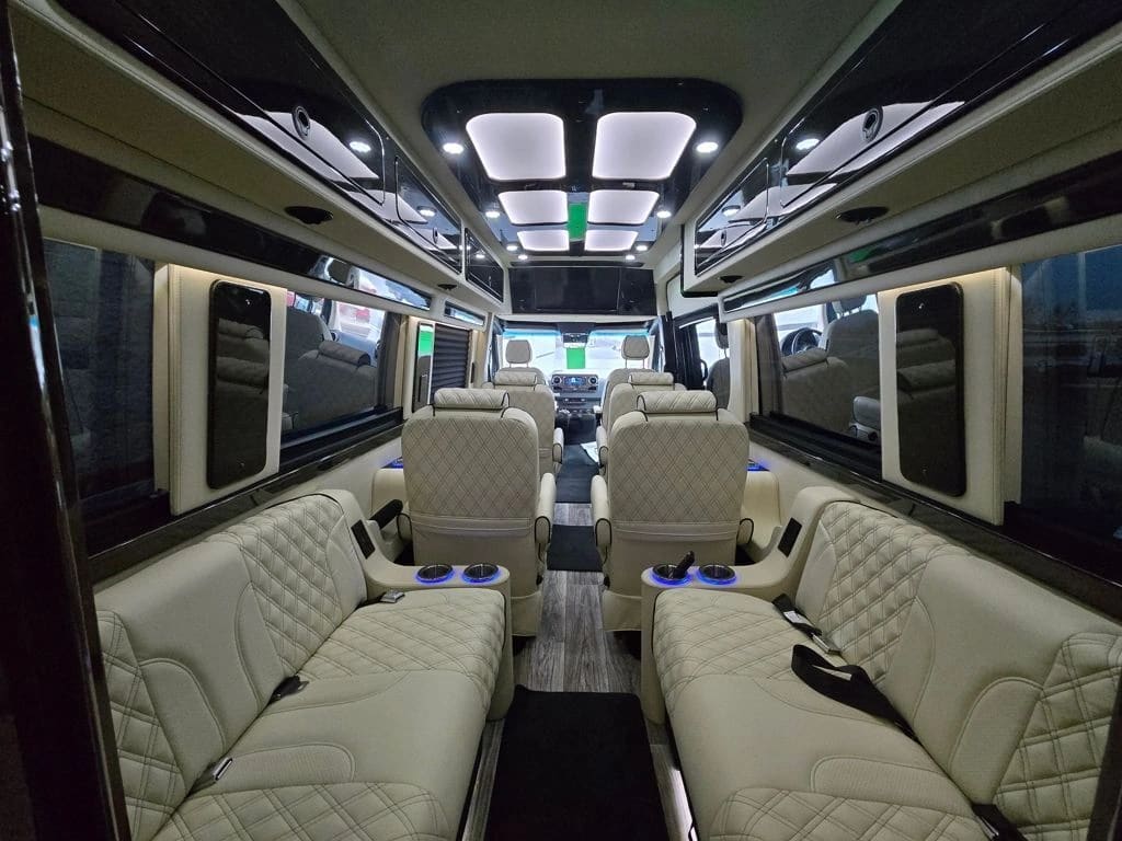 Opposing light-colored Sprinter benches with seats farther along the aisle
