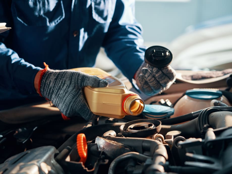 Oil change being performed on a vehicle in the service bay